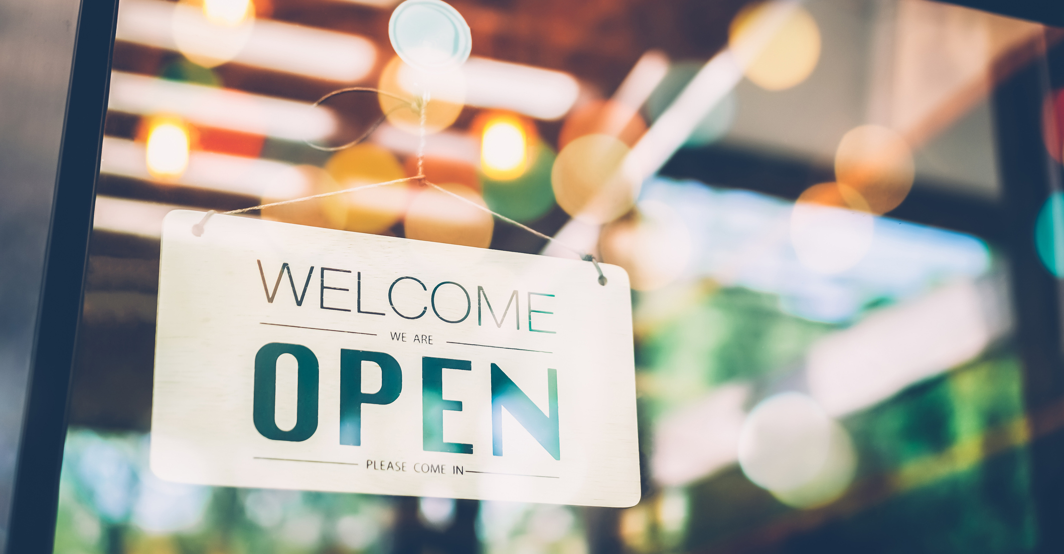 Open sign on cafe hang on door at entrance.